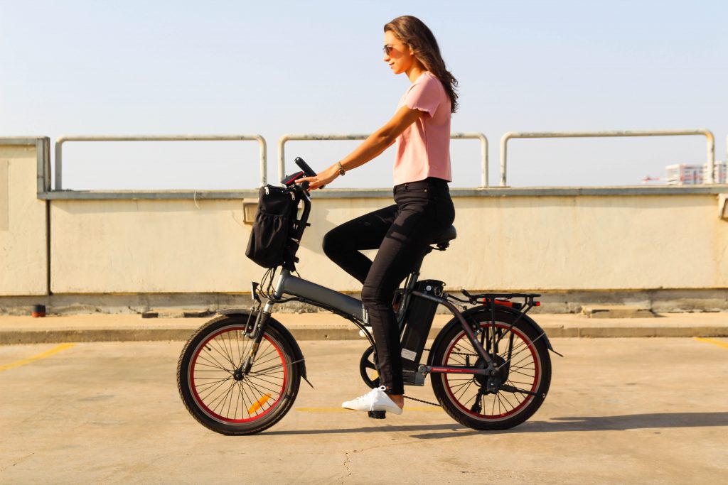 A young woman riding an electric bicycle